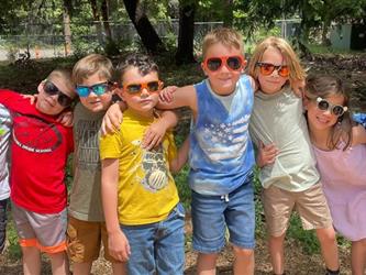 student smiling and wearing sunglasses